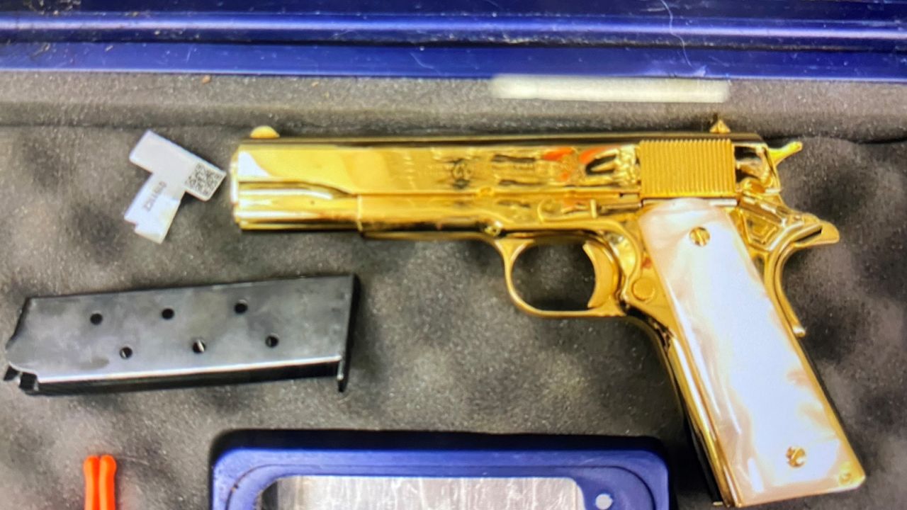 An undeclared 24-carat gold-plated handgun is pictured inside the luggage of a woman who arrived in Sydney, Australia. 