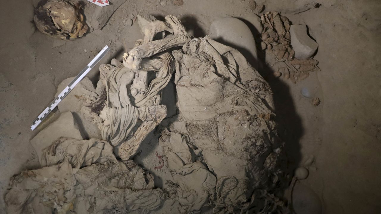 Skeletal remains and parts of the funerary bundle of a mummy found by Peruvian archaeologists are seen in the ruins of Cajamarquilla.
