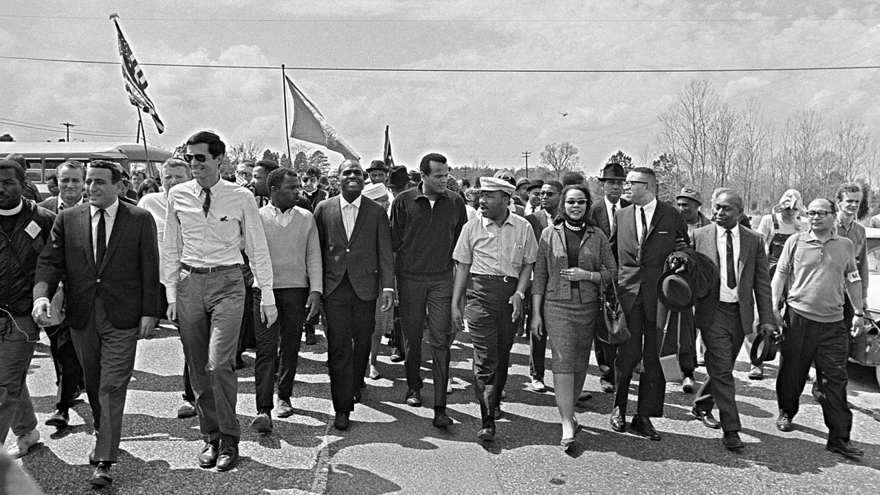 Dr. Martin Luther King, his wife Coretta Scott King, right, and Harry Belafonte at center marching near Montgomery, Alabama, on March 24, 1965.