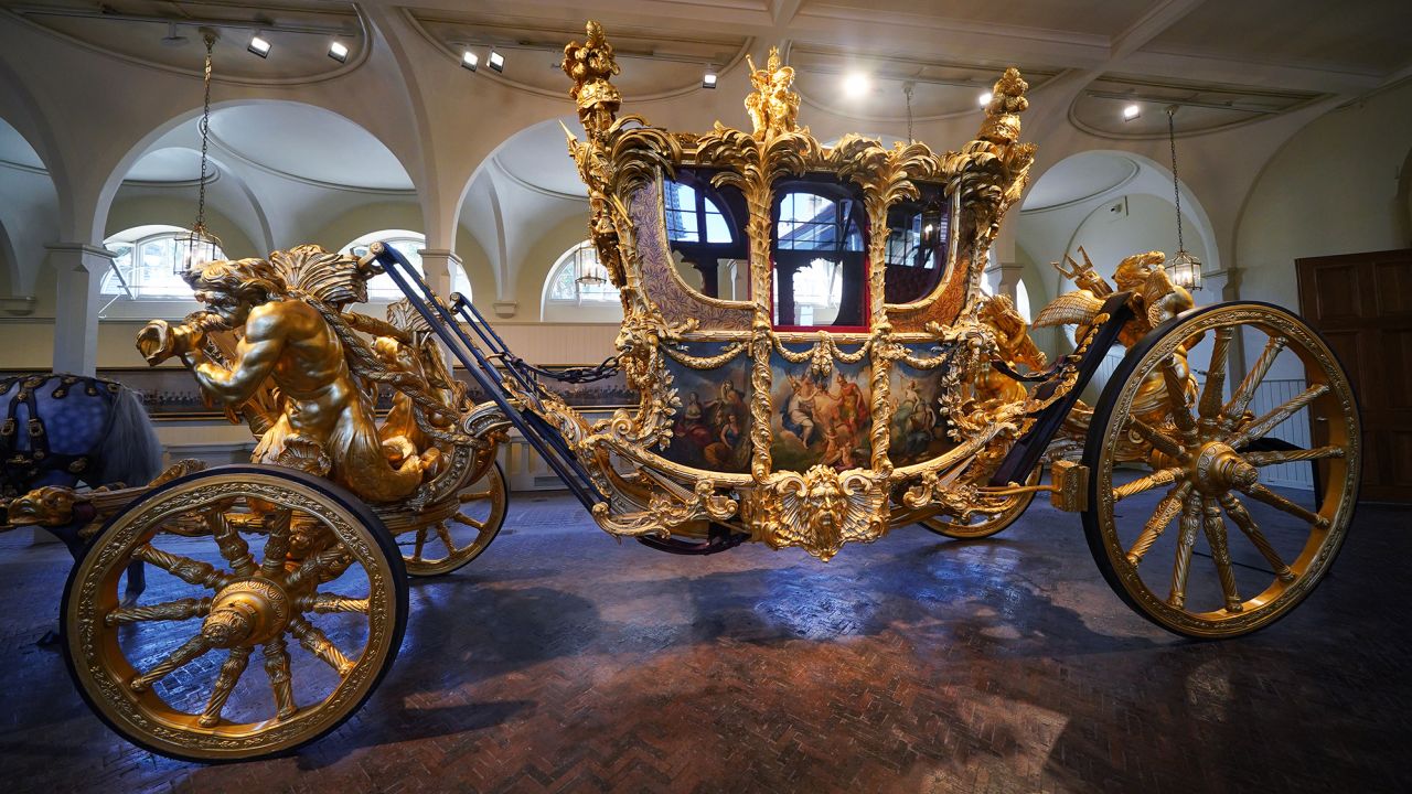The Gold State Coach on display at the Royal Mews in Buckingham Palace, London.