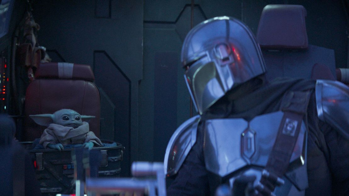 THE MANDALORIAN, from left: The Child (aka Baby Yoda), Pedro Pascal (as The Mandalorian), 'Chapter 6: The Prisoner', (Season 1, ep. 106, aired Dec. 13, 2019). photo: ©Disney+/Lucasfilm/Everett Collection