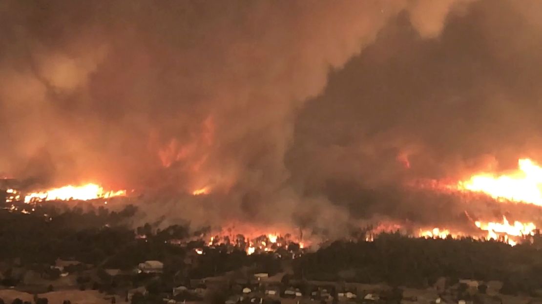 A fire tornado turns on July 26, 2018, over Lake Keswick Estates near Redding, California, during the Carr Fire, this image from Cal Fire video shows. 