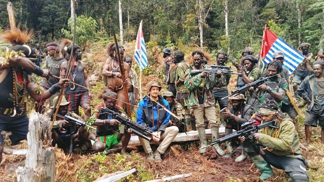 FILE PHOTO: A man who is identified as Philip Mehrtens, the New Zealand pilot who is said to be held hostage by a pro-independence group, sits among the separatist fighters in Indonesia's Papua region, March 6, 2023. The West Papua National Liberation Army (TPNPB)/Handout via REUTERS/File Photo