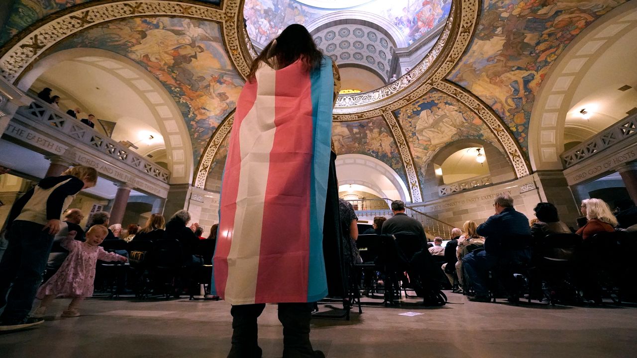 Glenda Starke wears a transgender flag as a counterprotest during a rally in favor of a ban on gender-affirming health care legislation on March 20, 2023, at the Missouri Statehouse in Jefferson City, Missouri.
