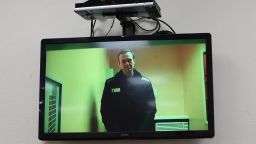 Russian opposition figure Alexey Navalny is seen on a screen via video link from a penal colony during a court hearing in Moscow.