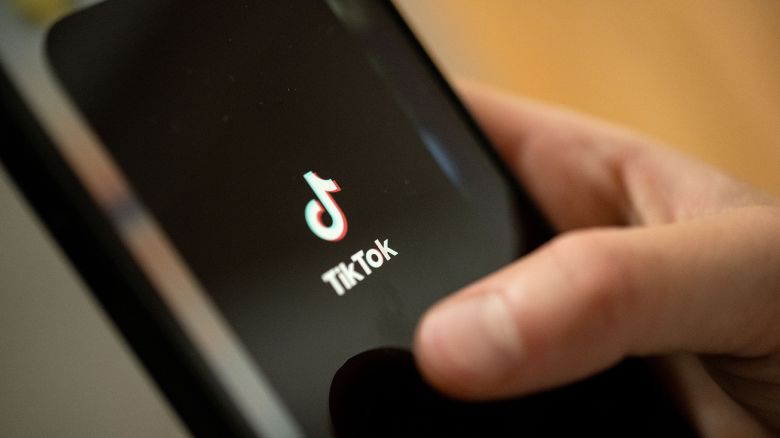 A teenager taps the TikTok logo on a smartphone in July 2022 in Stuttgart, Baden-Wuerttemberg, Germany.