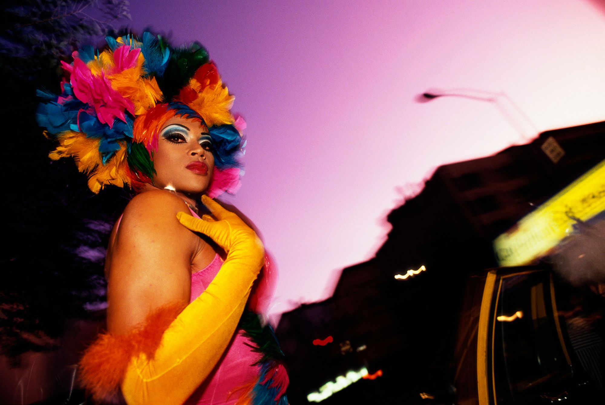 A man dons a feather headdress for the 2001 Wigstock, and annual drag festival held in Manhattan. (Photo by mark peterson/Corbis via Getty Images)