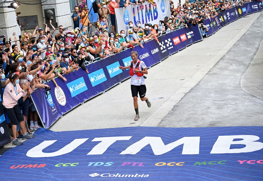 Courtney Dauwalter crosses the finish line for seventh place in the l'Ultra-Trail du Mont-Blanc (UTMB) distance race at Chamonix, eastern France, on August 28, 2021.