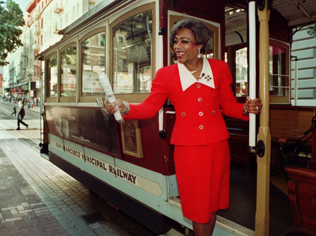 Drag queen Joan Jett-Black rides a cable car in San Francisco after announcing her candidacy for San Francisco mayor Monday, June 21, 1999. (AP Photo/Adam Turner)