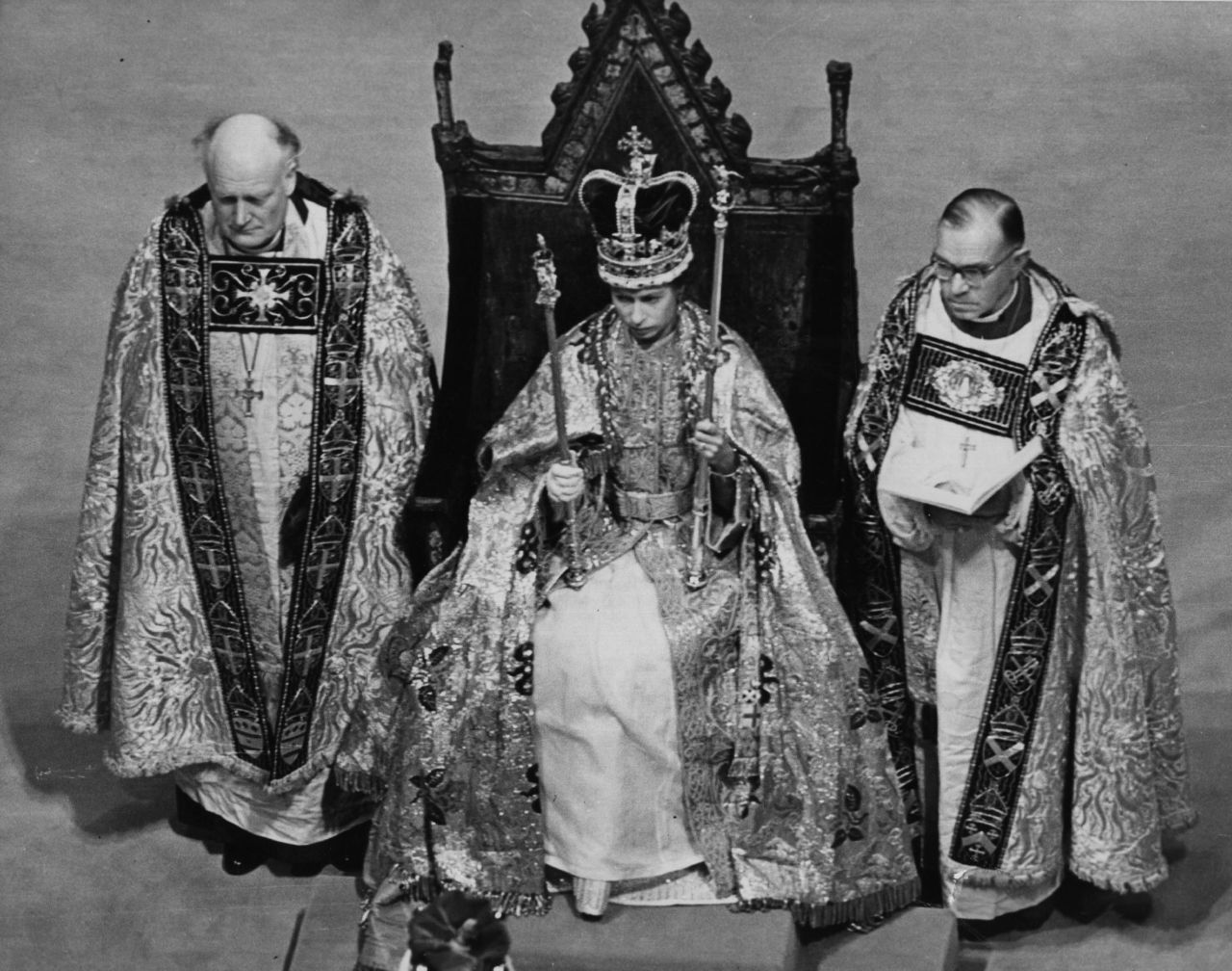 The Queen holds her symbols of office after the ceremony.
