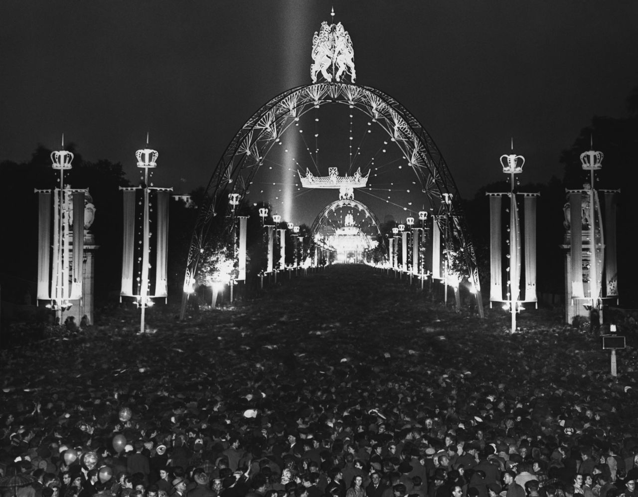 People celebrate the coronation from the Mall, which was specially lit for the occasion.