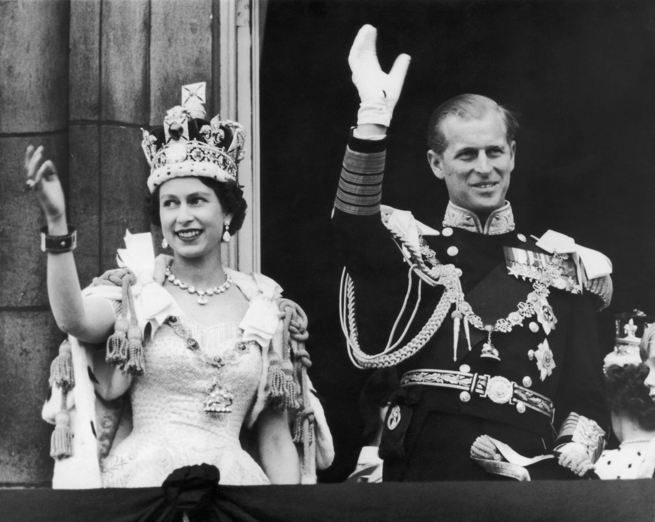 The Queen and Prince Philip wave to crowds from the balcony of Buckingham Palace after the coronation.