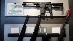 A semi-automatic rifle is displayed above shotguns at Rainier Arms Friday, April 14, 2023, in Auburn, Washington. 