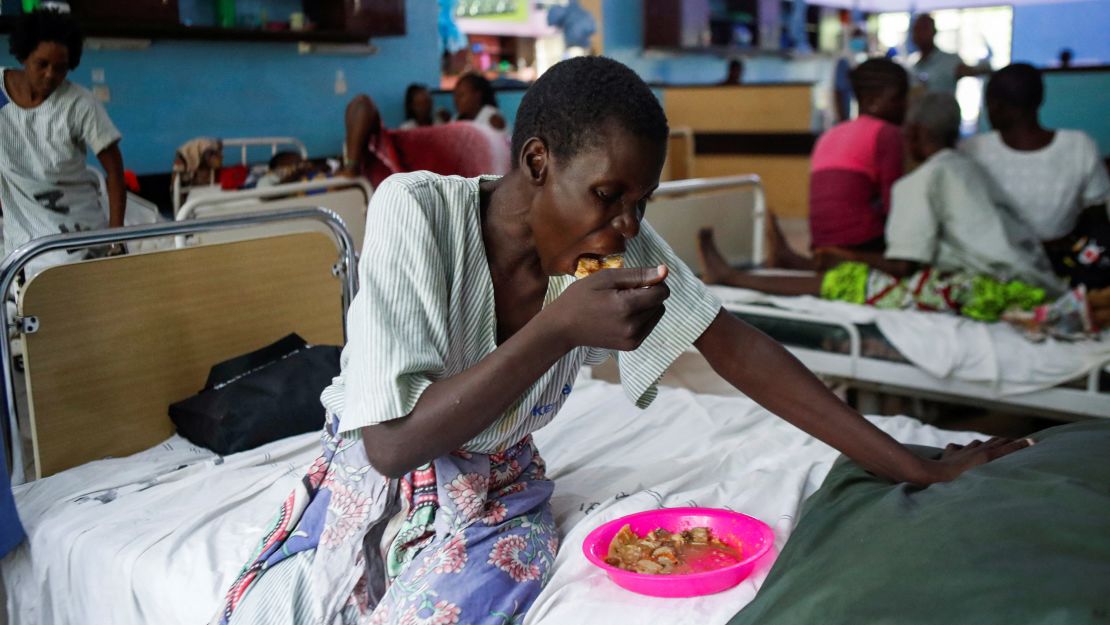 A survivor and a follower of Mackenzie's eats a meal inside a ward at the Malindi sub district hospital in April. 