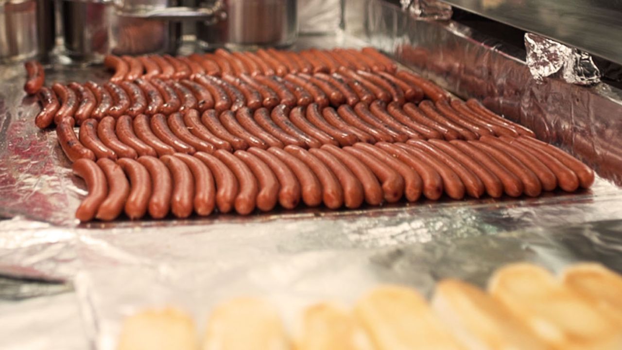 Gray's Papaya hot dogs being cooked.