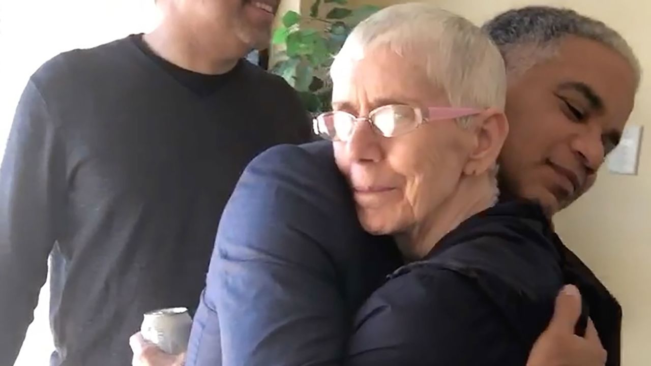 John Blake hugs his mother during a recent visit.