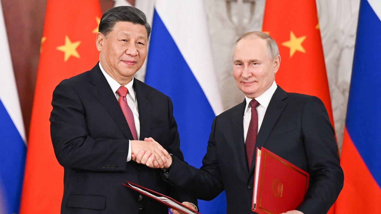 Chinese leader Xi Jinping and Russian President Vladimir Putin shake hands after signing a joint statement in Moscow on March 21, 2023. 