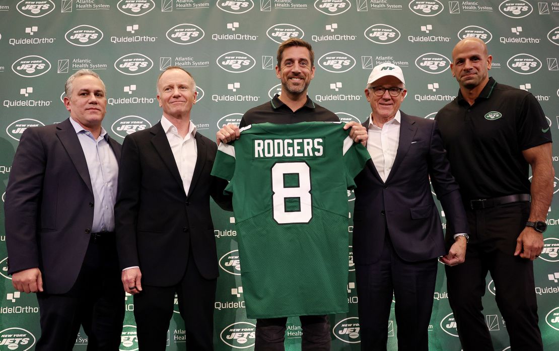 New York Jets team president Hymie Elhai, team owner Christopher Johnson, quarterback Aaron Rodgers, team owner Woody Johnson, and head coach Robert Saleh pose during the introductory press conference.