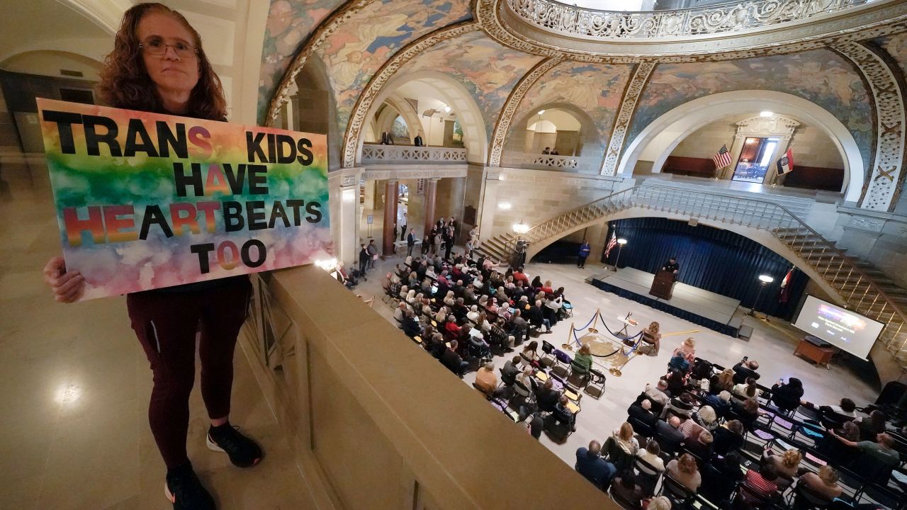 Julia Williams holds a sign in counterprotest during a rally in favor of a ban on gender-affirming health care legislation on Monday, March 20, 2023, at the Missouri Statehouse in Jefferson City.