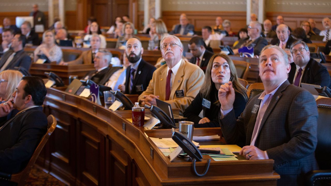 Kansas House Republican members watch the voting boards in early April as representatives seek to override a veto that would ban transgender athletes in the state.