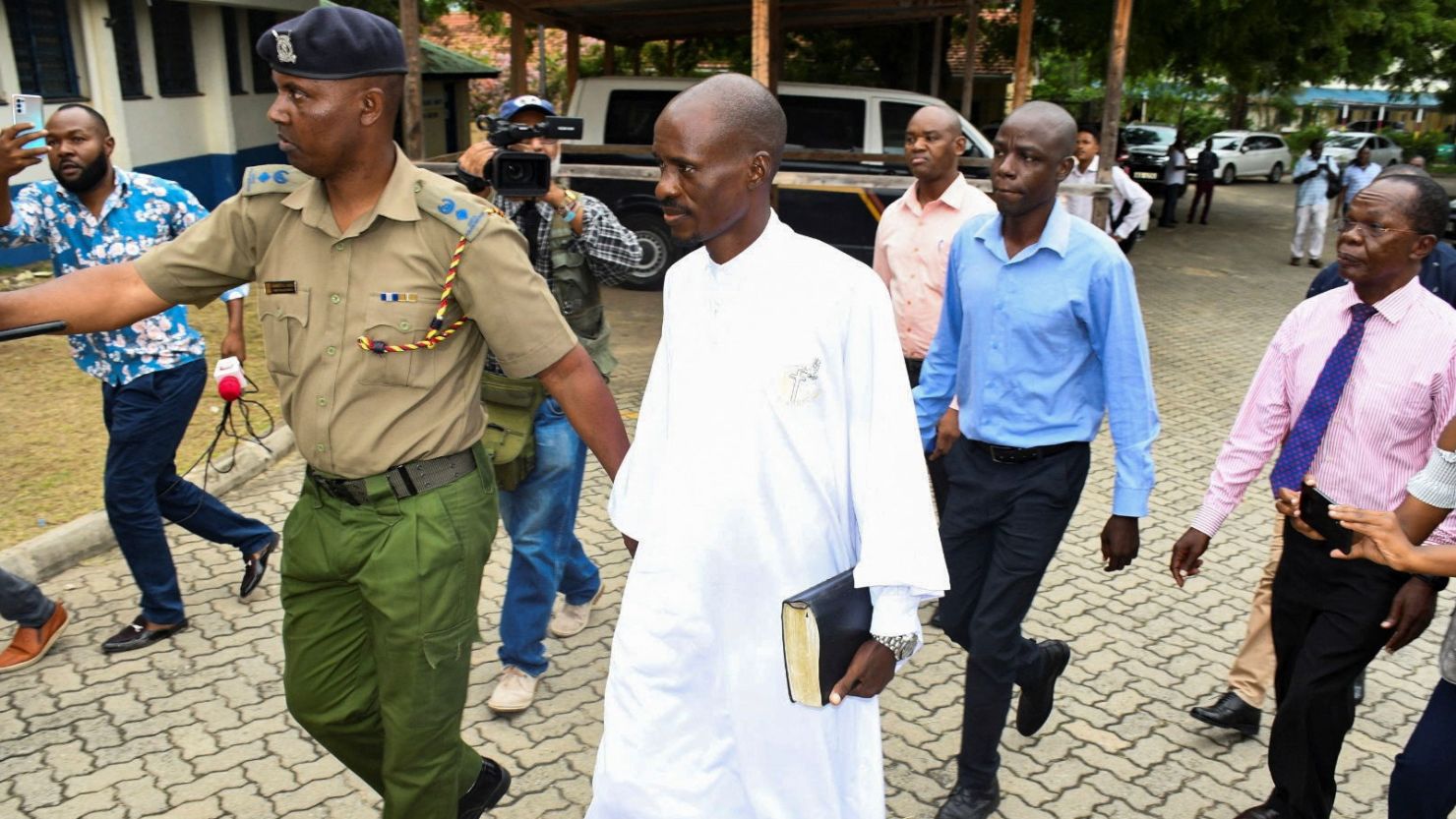 Detectives escort Ezekiel Ombok Odero, the Head of New Life Prayer Center/Church in Kilifi County, at the police headquarters for investigations into the Shakahola killings linked to pastor Paul Mackenzie, in Mombasa, Kenya April 27, 2023. REUTERS/Stringer