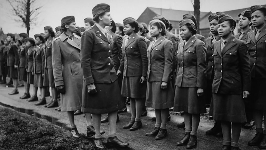 Maj. Charity E. Adams, center left, and Capt. Abbie N. Campbell inspect the first contingent of Black members of the Women's Army Corps -- the 6888 the Central Postal Directory Battalion -- somewhere in England.