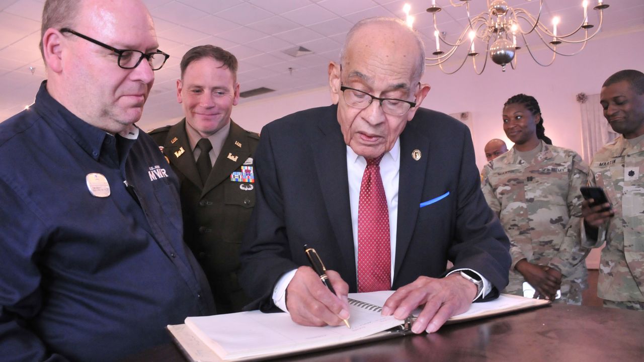 Retired Lt. Gen. Arthur J. Gregg signs the Gregg-Adams Club guestbook following the unveiling April 19 of the outside sign at the newly named Gregg-Adams Club. The ledger, which is at least 40 years old, still had Gregg's signature and other information from the day he retired there in 1981. Gregg shares the new name with Lt. Col. Charity Adams Earley, who commanded a postal unit in an overseas theater of operations during World War II.