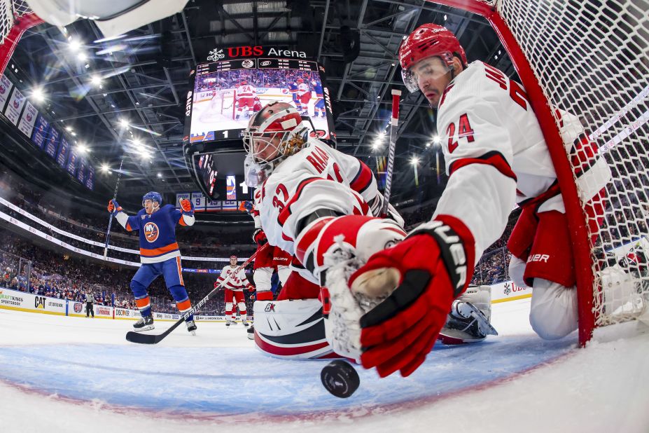 Carolina Hurricanes forward Seth Jarvis, right, tries to help his goalie, Antti Raanta, keep a puck out of the net during an NHL playoff game in Elmont, New York, on Friday, April 21. <a href="https://www.nhl.com/bruins/video/jarvis-lays-out-to-prevent-goal/t-277462458/c-16751456" target="_blank" target="_blank">Jarvis swatted the puck away</a>, but the Hurricanes still lost to the New York Islanders 5-1.