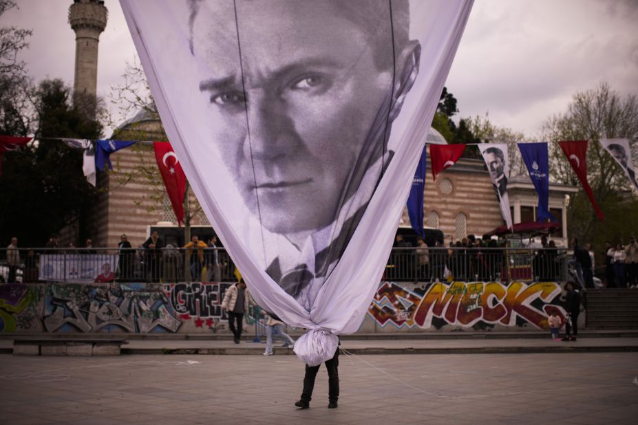 At the end of a political rally in Istanbul, a worker removes a giant banner with the image of Mustafa Kemal Atatürk, the founder of modern Turkey, on Wednesday, April 26.