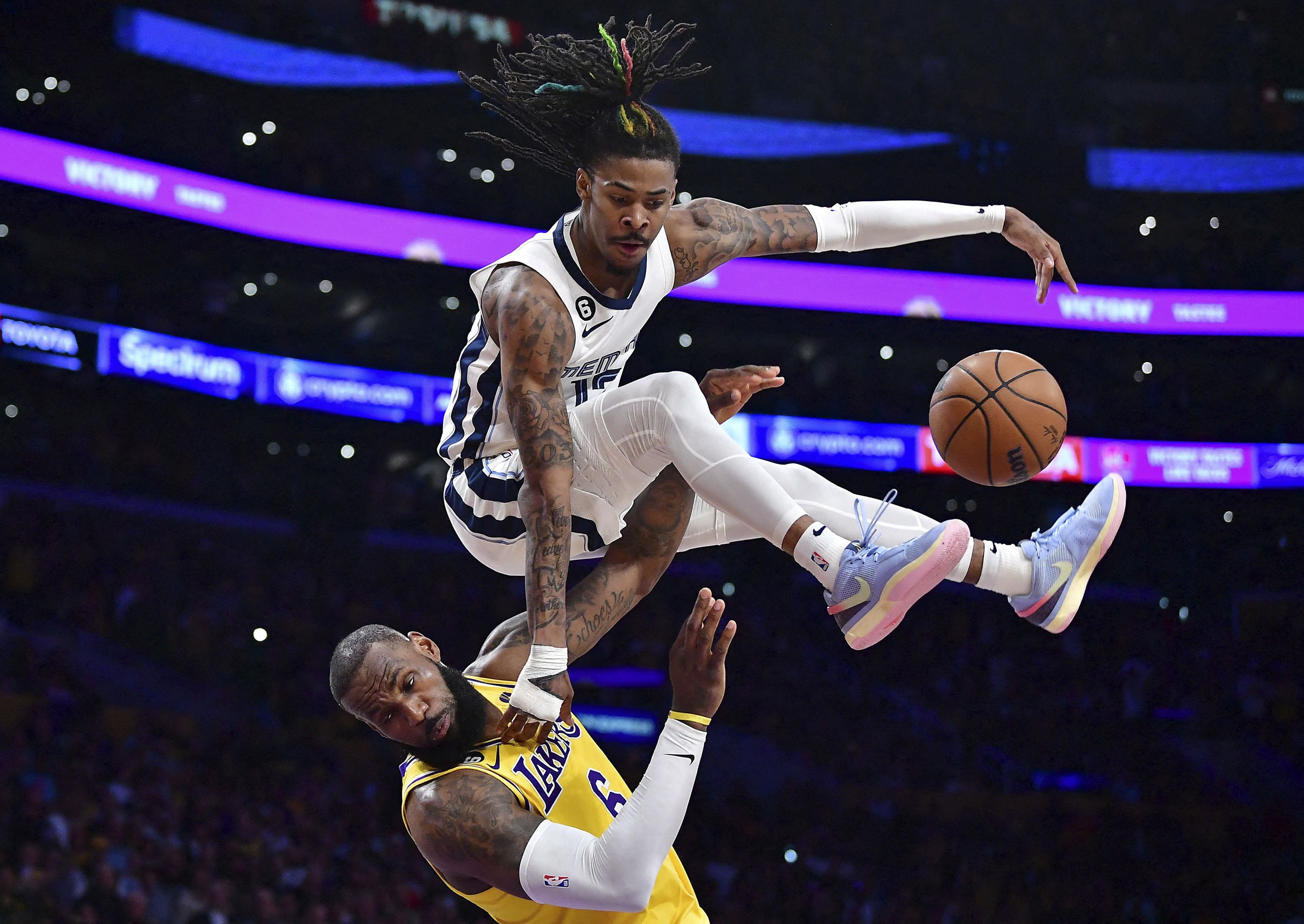 Memphis Grizzlies guard Ja Morant collides with Los Angeles Lakers forward LeBron James during an NBA playoff game on Monday, April 24.