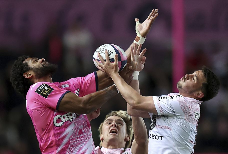 Stade Français' Peniasi Dakuwaqa, left, competes for a ball with Toulouse's Pierre Fouyssac during a Top 14 rugby match in Paris on Saturday, April 22.