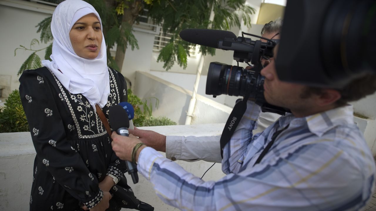 Rached Ghannouchi's (unseen) daughter Yusra speaks to media at Tunisia's main Islamist party Ennahda's headquarters on October 24, 2011 in Tunis. Rached Ghannouchi is the leader of the Islamist Ennahda party which claimed to have captured about 40 percent of the vote in the country's first free polls, as the cradle of the Arab Spring basked in praise for its democratic revolution. AFP PHOTO / LIONEL BONAVENTURE (Photo credit should read LIONEL BONAVENTURE/AFP via Getty Images)
