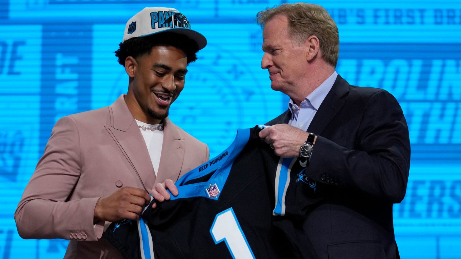Alabama quarterback Bryce Young gets a Carolina Panthers jersey from NFL Commissioner Roger Goodell.