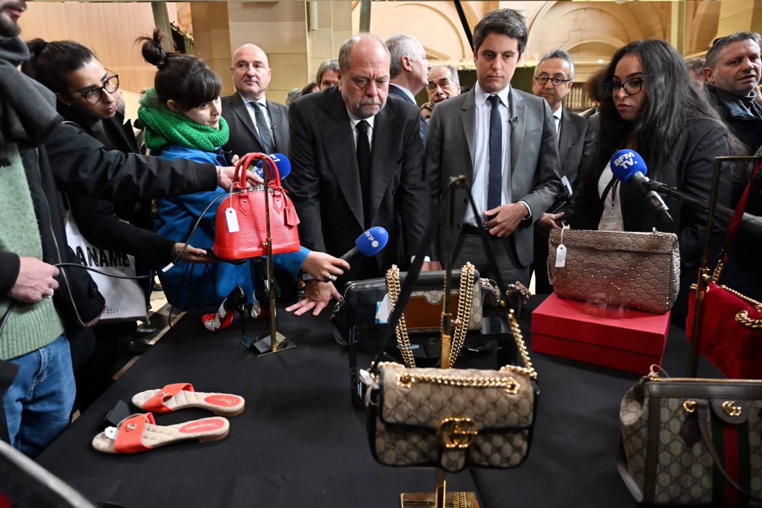 French Justice Minister Eric Dupond-Moretti and Junior Minister for Public Accounts Gabriel Attal look at bags and shoes during the auction.