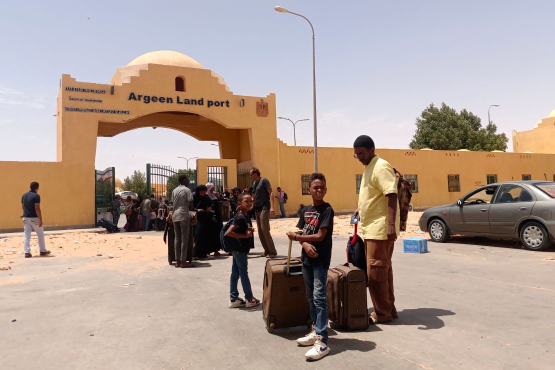 People cross into Egypt from Sudan on April 27, 2023. Several Sudanese citizens told CNN they cannot flee the conflict-ridden country because their passports are held at evacuated Western embassies.