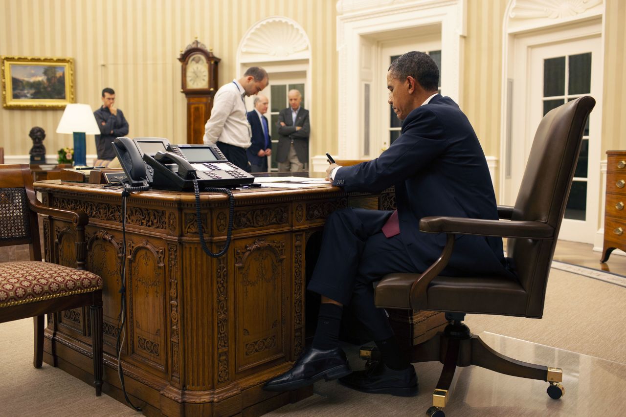 Obama reviews his remarks before his televised statement.