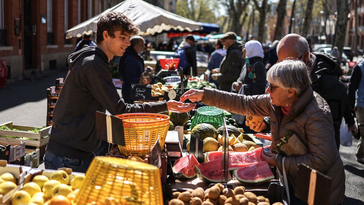 A customer shops at an outdoor fruit and vegetable market in Toulouse, southwestern France, on March 5, 2023.