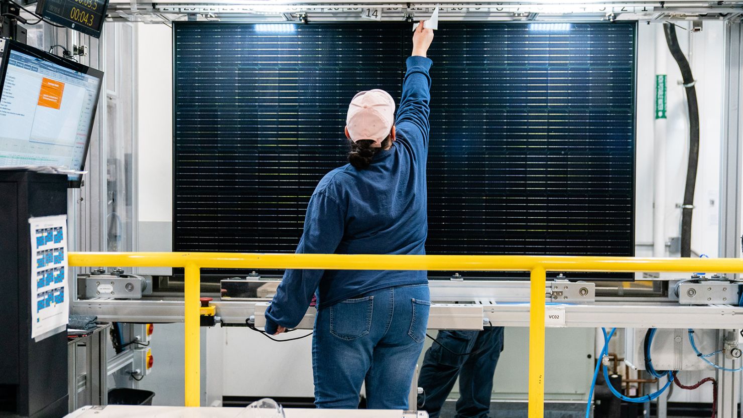 A quality control worker checks a solar panel at the Hanwha QCells solar cell and module manufacturing facility in Dalton, Georgia, in October 2022.