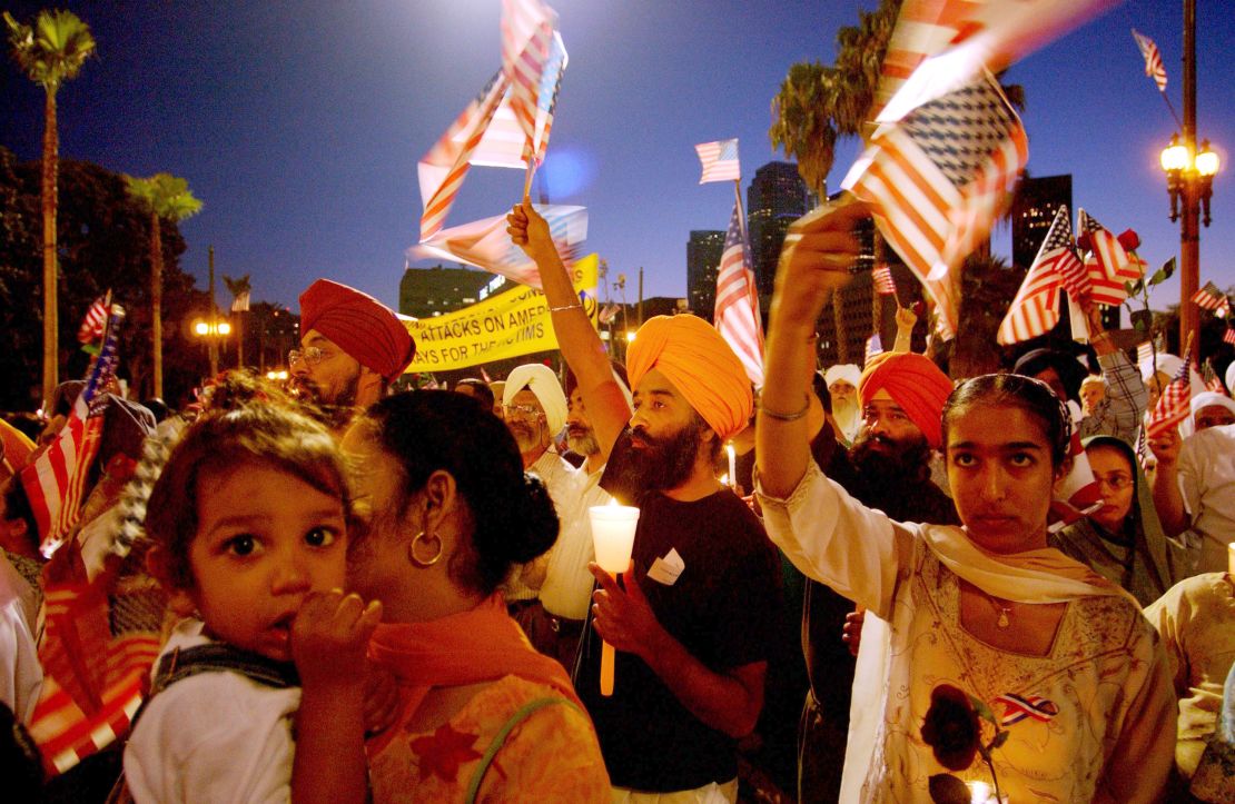 Sikhs in Los Angeles wave American flags during a memorial for the 9/11 victims. Several Sikhs were targeted in the days after the attacks as some wrongly associated their turbans with terrorists. 