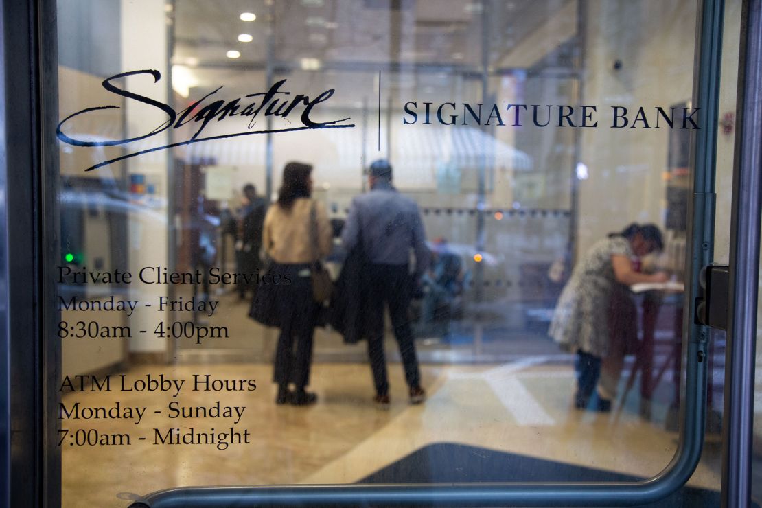 Customers wait inside a Signature Bank branch in New York, the United States, on March 13, 2023.