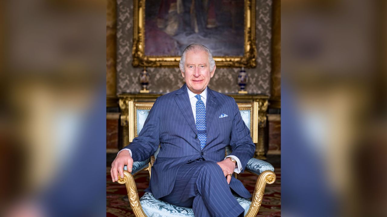King Charles III poses for a photograph in The Blue Drawing Room astatine Buckingham Palace, London. 