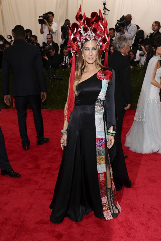 Sarah Jessica Parker also attends the 2015 Met Gala in an ornate flaming red headpiece by Philip Treacy, and a dress from her collaboration with H&M.