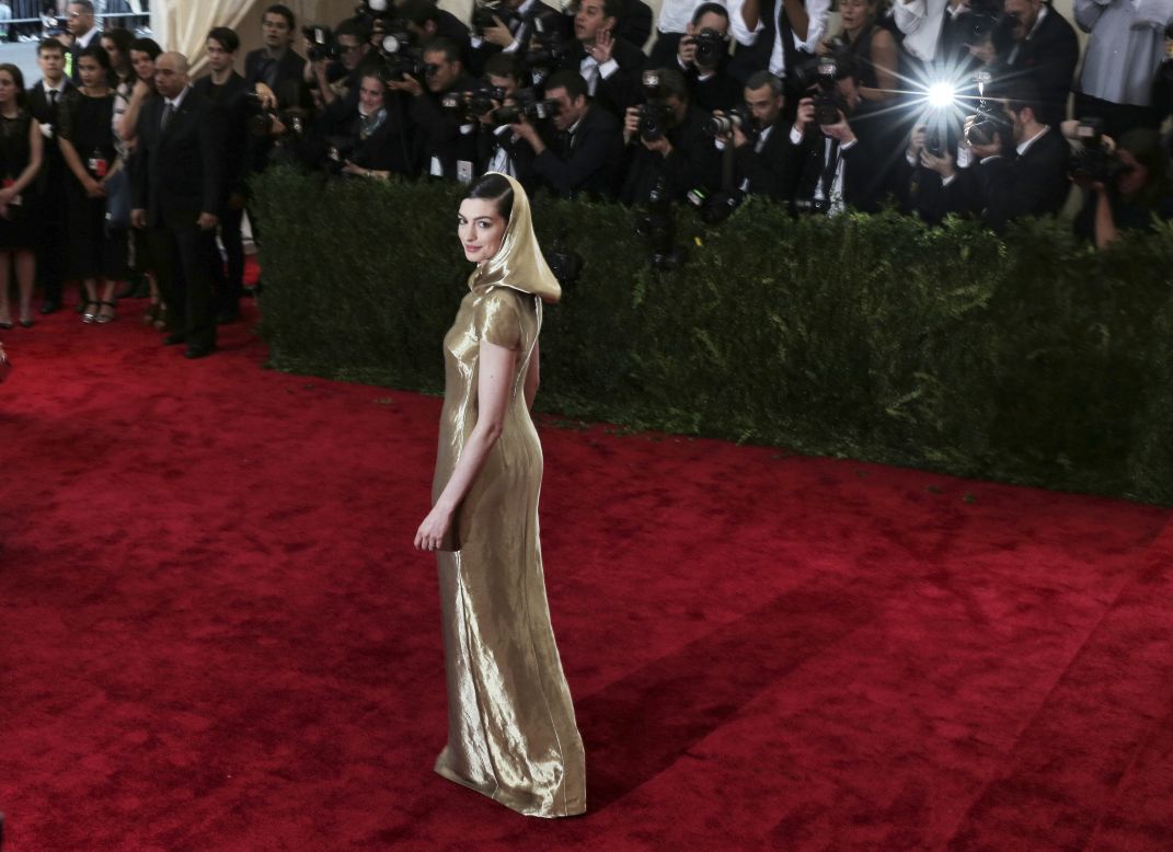 Anne Hathaway the same year (2015) in a custom golden Ralph Lauren Collection dress with draped hood.