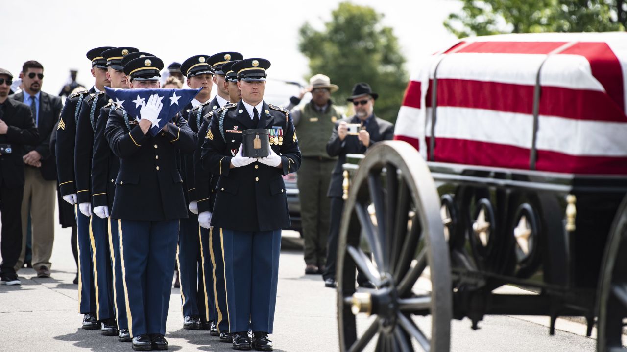 Soldiers from the Old Guard with a flag and urn holding remains of Isaac Hart.
