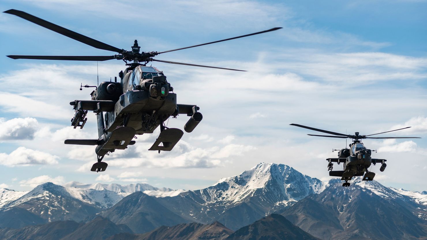 In this photo released by the U.S. Army, AH-64D Apache Longbow attack helicopters from the 1st Attack Battalion, 25th Aviation Regiment, fly over a mountain range near Fort Wainwright, Alaska, on June 3, 2019.