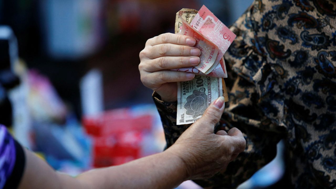 A shopper receives change for fresh produce bought at the Mercado 4 street market ahead of Paraguay's national election, in Asuncion, Paraguay April 28, 2023.