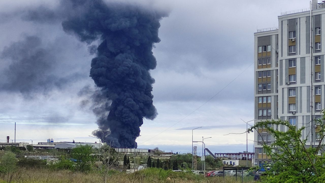 Smoke rises over a fuel tank following an alleged drone attack in Sevastopol, Crimea.