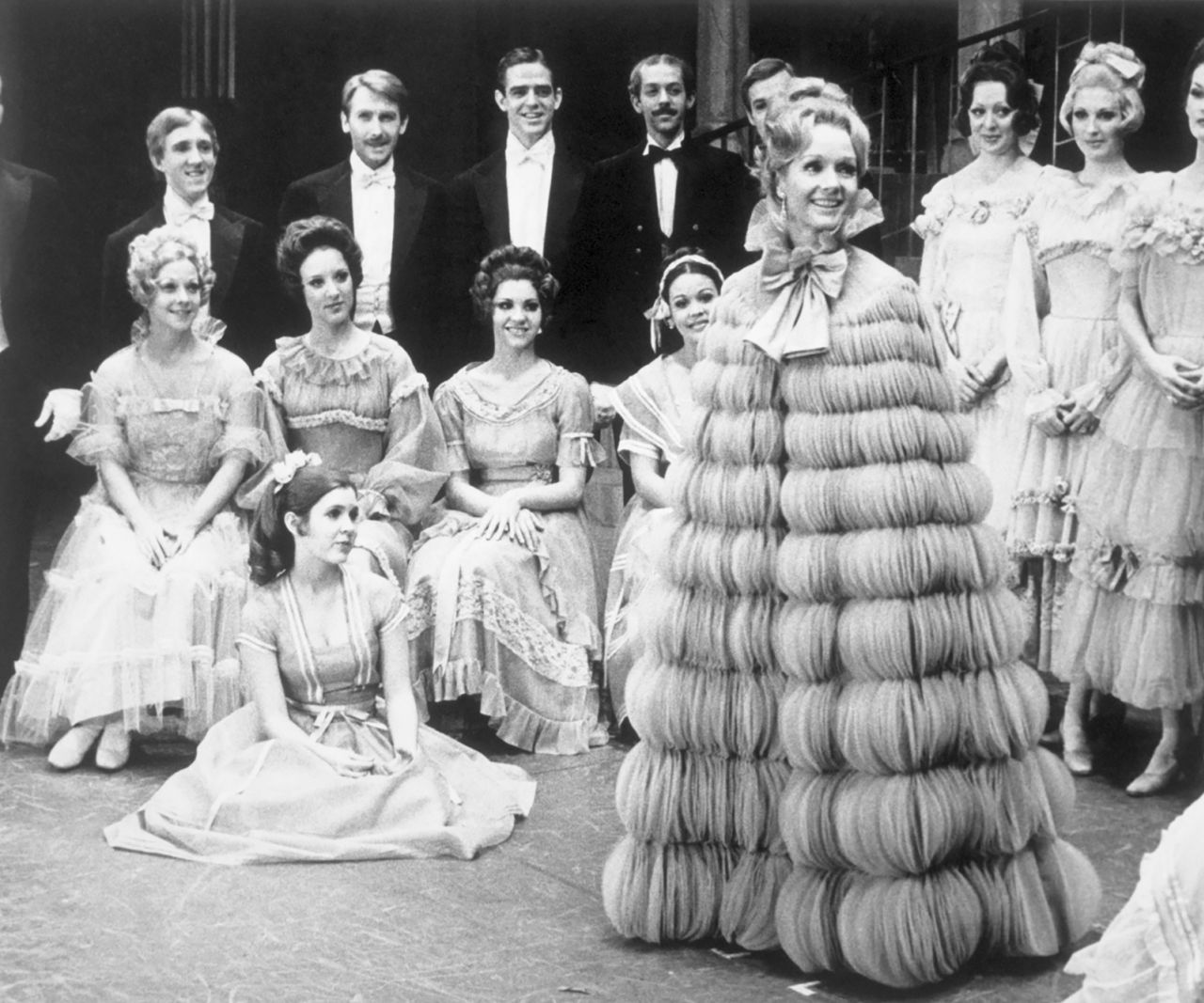 A teenage Fisher, sitting on the floor, appears with her mother, front right, in a Broadway remake of the musical "Irene" in 1973. Fisher dropped out of high school at age 15 and was featured in the musical as part of the chorus.