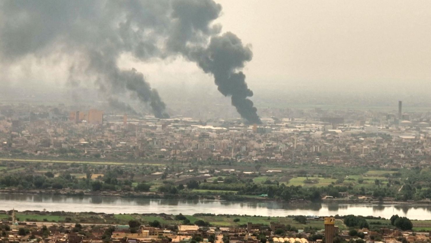 This image grab taken from AFPTV video footage on April 28, 2023, shows an aerial view of black smoke rising over Khartoum, Sudan. 