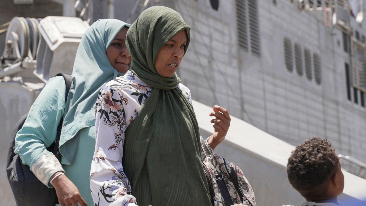 People disembark from the US Navy fast transport ship, the USNS Brunswick in Saudi Arabia.